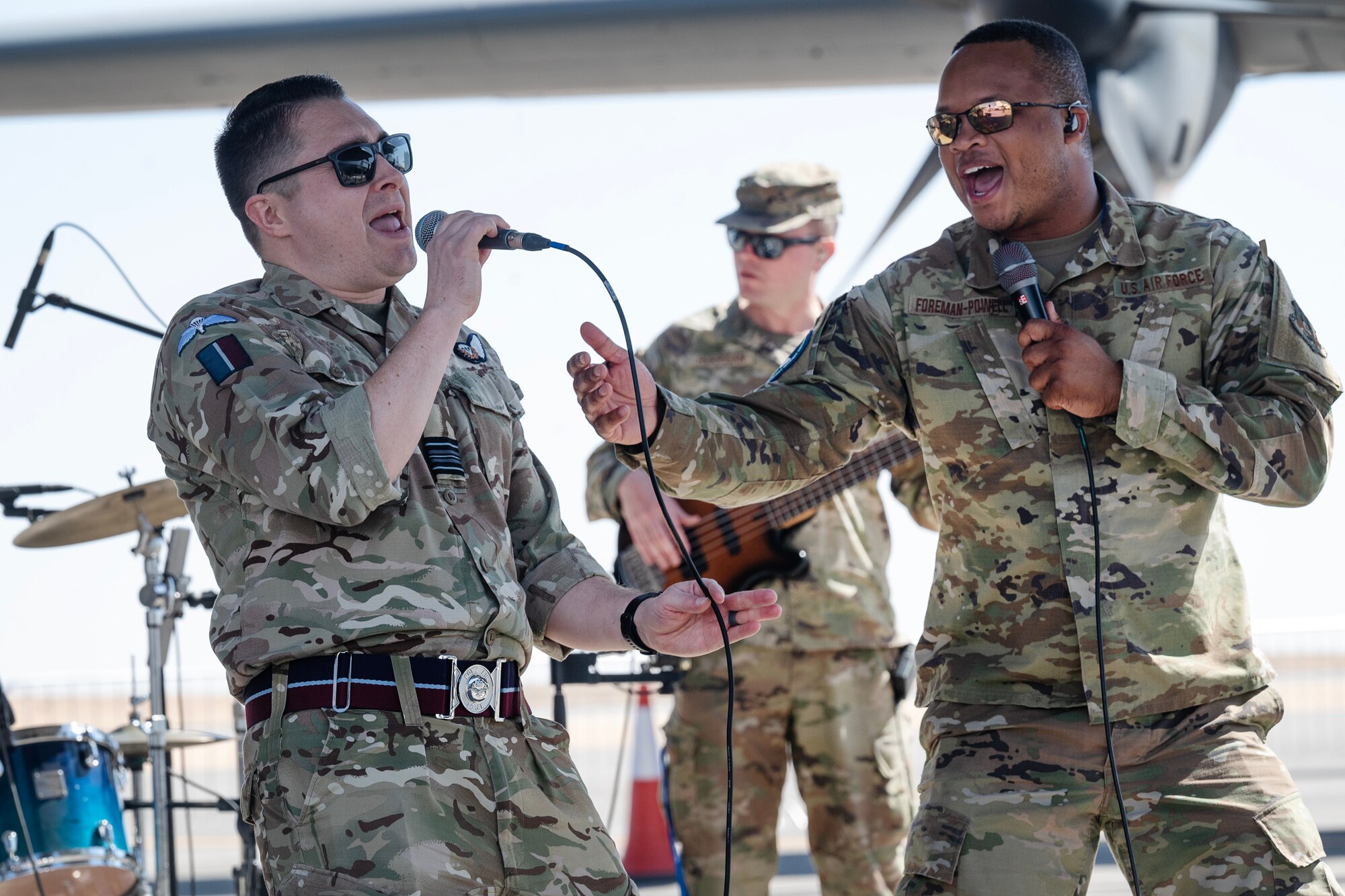 Two people sing on stage.