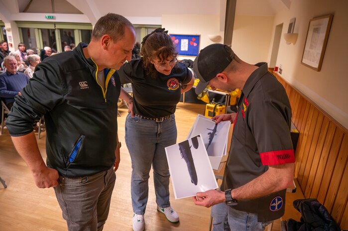 A local tail spotter shares photos with members of the 99th Expeditionary Reconnaissance Squadron.