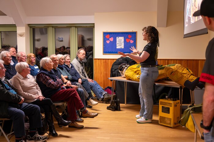Members of the local community listen to a brief.