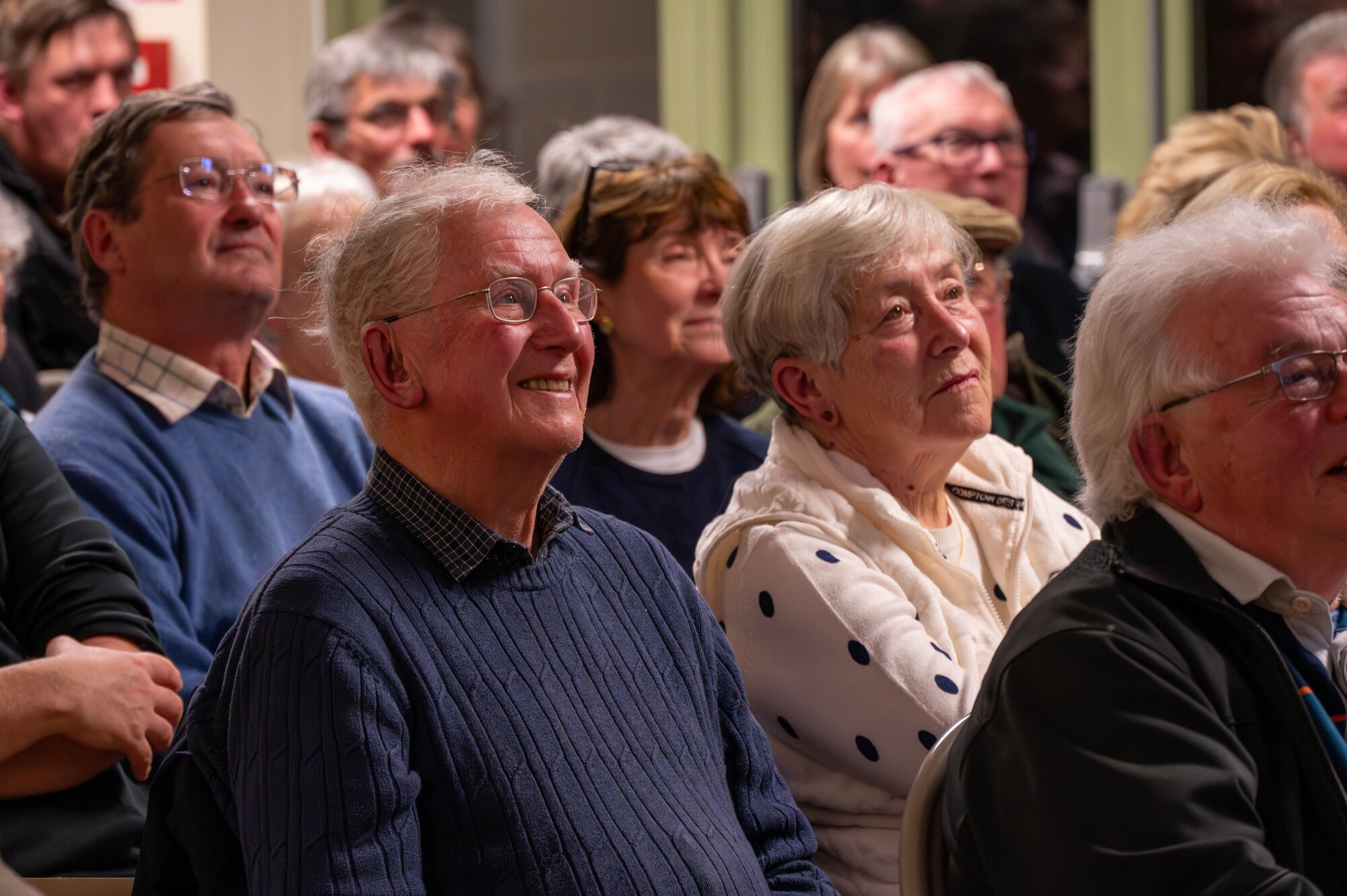 Members of the local community listen to a brief.