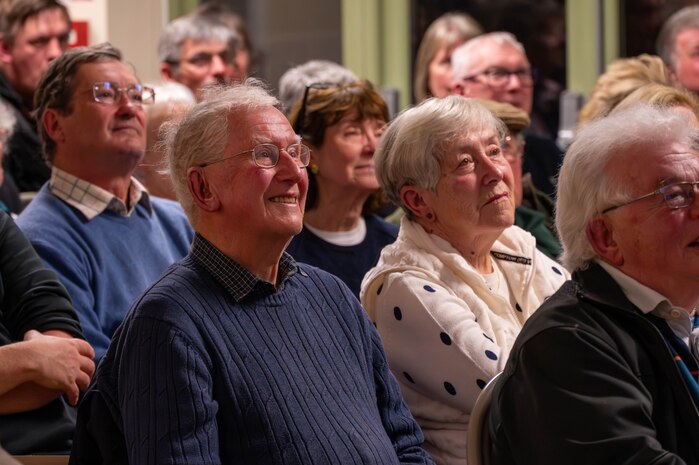 Members of the local community listen to a brief.