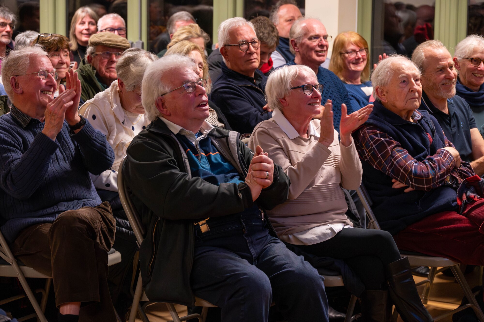 Members of the local community applaud.