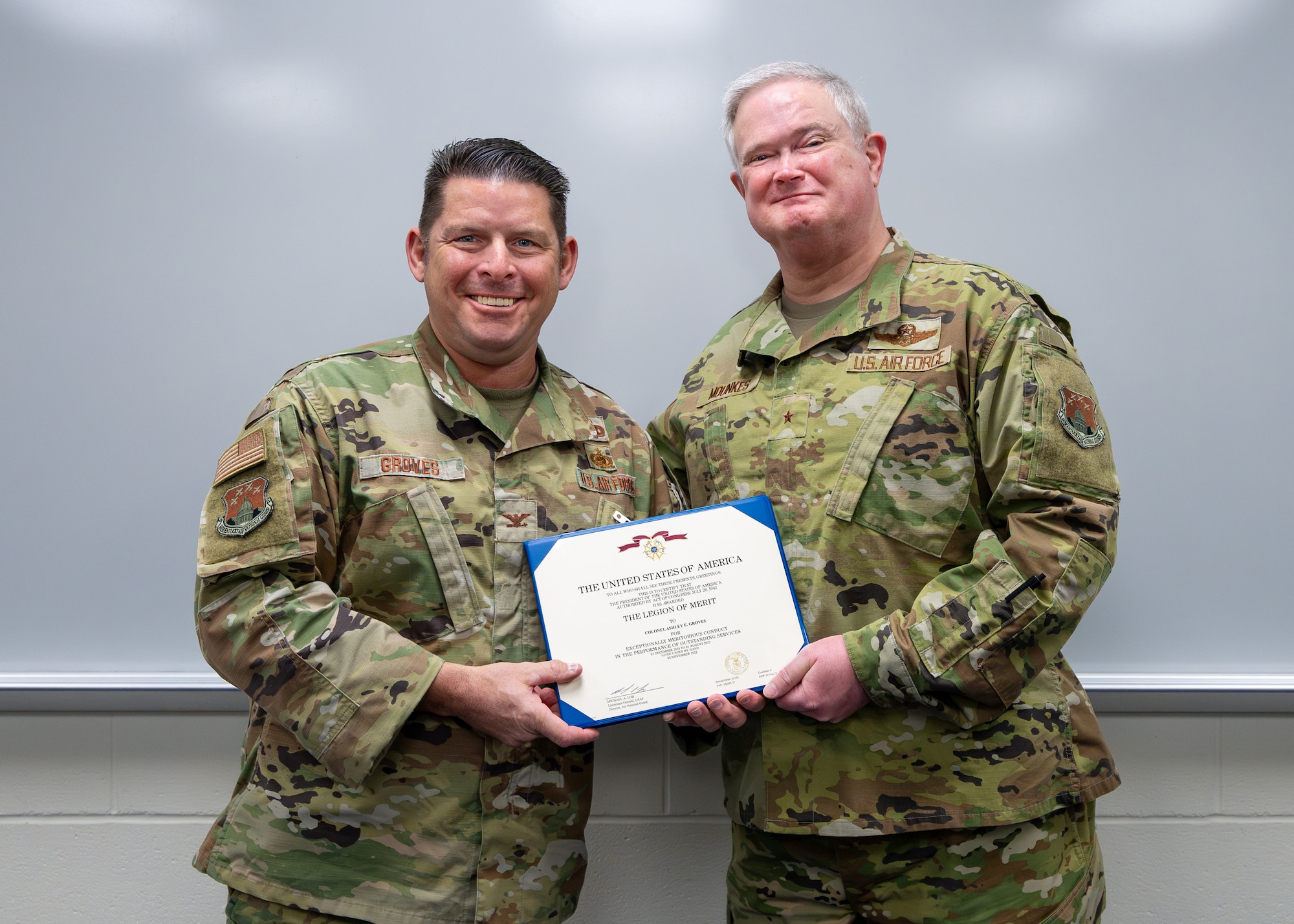 Col. Ash Groves, left, director of Air Staff at Joint Force Headquarters, Kentucky National Guard, receives the Legion of Merit from Brig. Gen. David Mounkes, the Kentucky National Guard’s assistant adjutant general for Air, during a ceremony at the Kentucky Air National Guard Base in Louisville, Ky., Dec. 10, 2024. Groves earned the honor for superior performance as commander of the Kentucky Air Guard’s 123rd Maintenance Group from Dec. 1, 2018 to Aug.1, 2022. (U.S. Air National Guard photo by Dale Greer)