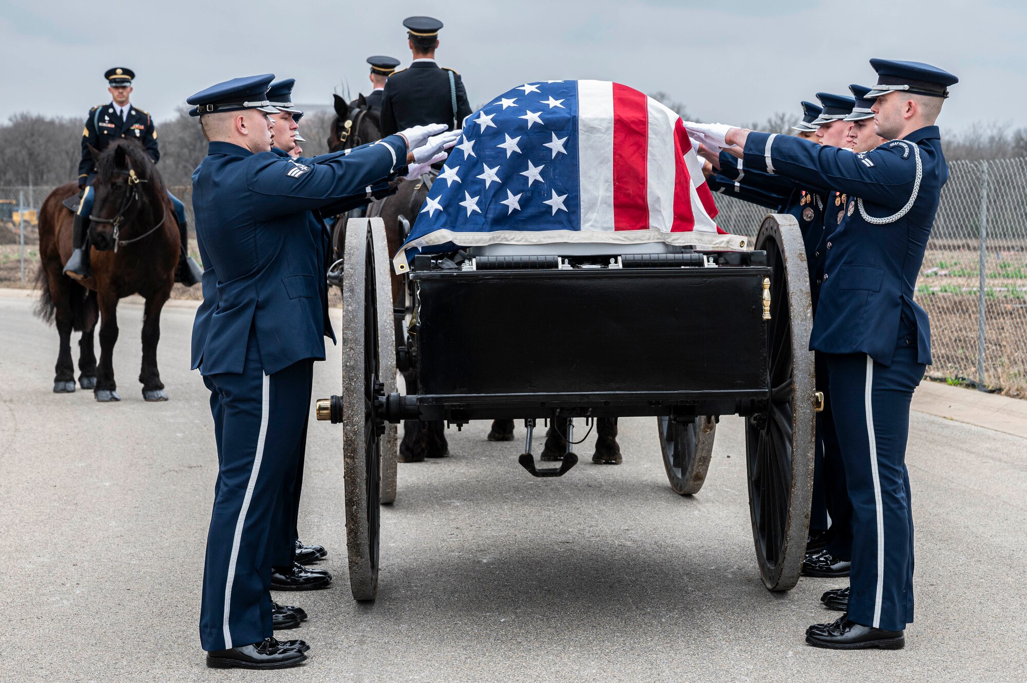 Soldiers with the Fort Sam Houston Caisson Section carry the flag-draped casket of the fifth Chief Master Sgt. of the Air Force Robert D. Gaylor during his interment ceremony, Feb. 10, 2024 at Fort Sam Houston National Cemetery, Texas. Gaylor spent more than seven decades improving the Air Force through its people. He was an active proponent of professional military education and delivered seminars frequently in person and online until his passing. (U.S. Air Force photo by Tristin English).