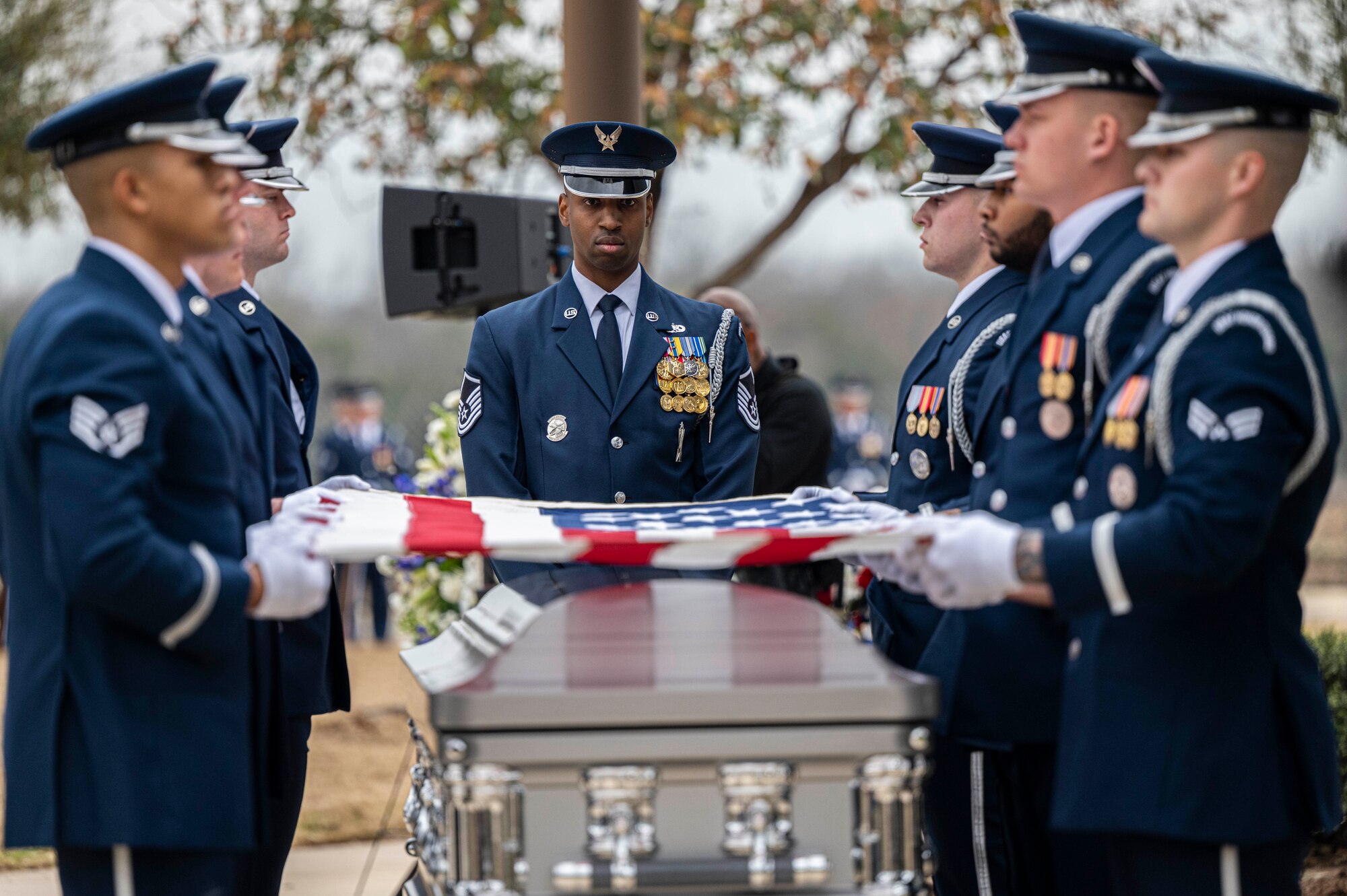 Members of the U.S. Air Force Honor Guard fold the U.S. flag during the interment with full military honors of the fifth Chief Master Sgt. of the Air Force Robert D. Gaylor, Feb. 10, 2024 at Fort Sam Houston National Cemetery, Texas. Gaylor championed Air Force professional military education in the late 1960s and 1970s before he was promoted to Chief Master Sgt. of the Air Force in 1977. He continued to educate and inspire service members for more than 40 years after his retirement from military service. (U.S. Air Force photo by Tristin English).
