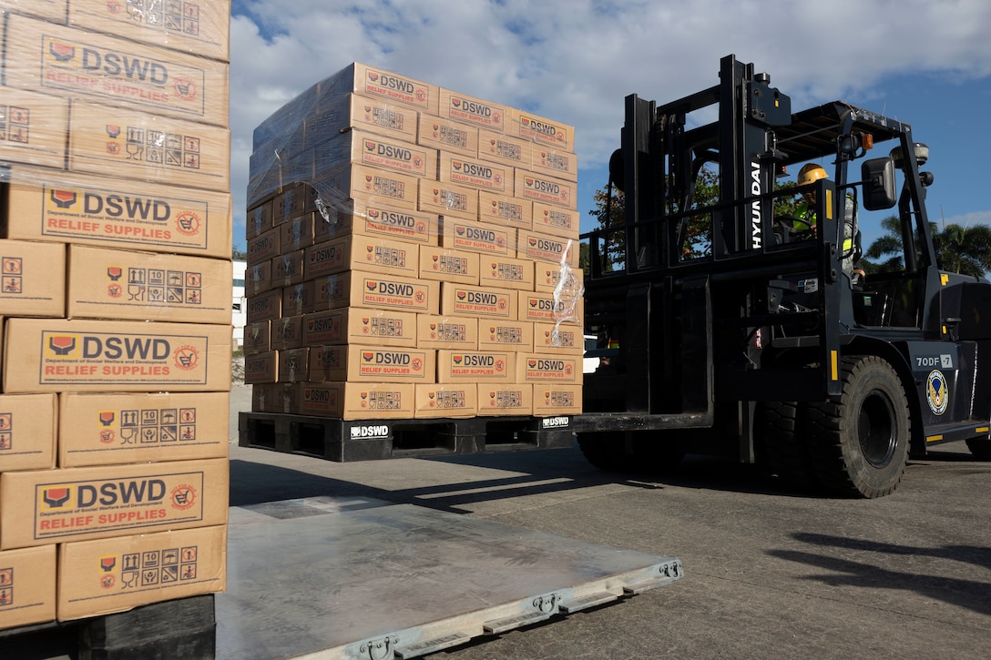 A Philippine Air Force service member palletizes Department of Social Welfare and Development family food packs at Villamor Airbase, Pasay City, Philippines, Feb. 11, 2024. At the request of the Government of the Philippines, the U.S. Marines of III Marine Expeditionary Force are supporting the U.S. Agency for International Development in providing foreign humanitarian assistance to the ongoing disaster relief mission in Mindanao. The forward presence and ready posture of III MEF assets in the region facilitated rapid and effective response to crisis, demonstrating the U.S.’s commitment to Allies and partners during times of need. (U.S. Marine Corps photo by Sgt. Savannah Mesimer)