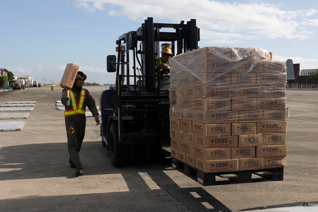 Philippine Air Force service members palletize Department of Social Welfare and Development family food packs at Villamor Airbase, Pasay City, Philippines, Feb. 11, 2024. At the request of the Government of the Philippines, the U.S. Marines of III Marine Expeditionary Force are supporting the U.S. Agency for International Development in providing foreign humanitarian assistance to the ongoing disaster relief mission in Mindanao. The forward presence and ready posture of III MEF assets in the region facilitated rapid and effective response to crisis, demonstrating the U.S.’s commitment to Allies and partners during times of need. (U.S. Marine Corps photo by Sgt. Savannah Mesimer)