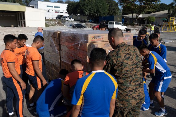 U.S. Marines with Marine Aerial Refueler Transport Squadron 152, 1st Marine Aircraft Wing, alongside Philippine military and coast guard service members palletize Department of Social Welfare and Development family food packs in preparation for transportation at Villamor Airbase, Pasay City, Philippines, Feb. 11, 2024. At the request of the Government of the Philippines, the U.S. Marines of III Marine Expeditionary Force are supporting the U.S. Agency for International Development in providing foreign humanitarian assistance to the ongoing disaster relief mission in Mindanao. The forward presence and ready posture of III MEF assets in the region facilitated rapid and effective response to crisis, demonstrating the U.S.’s commitment to Allies and partners during times of need. (U.S. Marine Corps photo by Sgt. Savannah Mesimer)