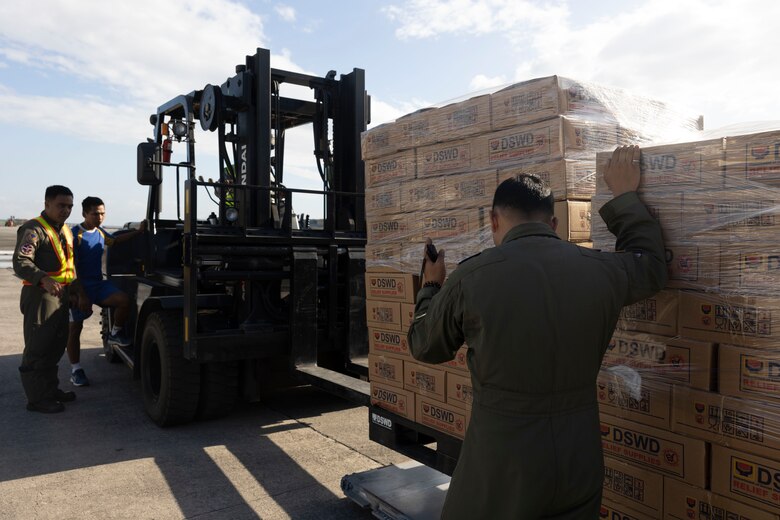 Philippine Air Force service members palletize Department of Social Welfare and Development family food packs at Villamor Airbase, Pasay City, Philippines, Feb. 11, 2024. At the request of the Government of the Philippines, the U.S. Marines of III Marine Expeditionary Force are supporting the U.S. Agency for International Development in providing foreign humanitarian assistance to the ongoing disaster relief mission in Mindanao. The forward presence and ready posture of III MEF assets in the region facilitated rapid and effective response to crisis, demonstrating the U.S.’s commitment to Allies and partners during times of need. (U.S. Marine Corps photo by Sgt. Savannah Mesimer)