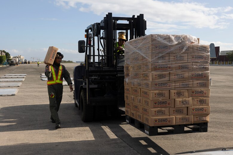 Philippine Air Force service members palletize Department of Social Welfare and Development family food packs at Villamor Airbase, Pasay City, Philippines, Feb. 11, 2024. At the request of the Government of the Philippines, the U.S. Marines of III Marine Expeditionary Force are supporting the U.S. Agency for International Development in providing foreign humanitarian assistance to the ongoing disaster relief mission in Mindanao. The forward presence and ready posture of III MEF assets in the region facilitated rapid and effective response to crisis, demonstrating the U.S.’s commitment to Allies and partners during times of need. (U.S. Marine Corps photo by Sgt. Savannah Mesimer)