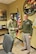 two men wearing u.s. army uniforms shake hands in a recruiting office.