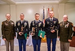 Left to right: Army Col. Jeremey Davis, 50th Regional Support Group (RSG) commander; Spc. Nicanor Echeverria, combat medic assigned to Bravo Company, 260th Military Intelligence Battalion, Army Staff Sergeant Austin Jensen, S-2 noncommissioned officer in charge assigned to Headquarters and Headquarters Company, 50th RSG; Army Sgt. Michael Parkins, utilities equipment repairman assigned to the 631st Support Maintenance Company; and Command Sgt. Maj. Thomas Delano, 50th RSG command sergeant major, pose after announcing the winners of the 50th RSG’s Best Warrior Competition (BWC) during an awards ceremony at Camp Blanding Joint Training Center on Feb. 3, 2024. During the brigade-level contest, Echeverria earned the title of “Solider of the Year,” Jensen won “NCO of the Year,” and Parkins received the “Warrior Spirit” award. Echeverria and Jensen will go on to represent the 50th RSG at the state-level BWC. The 50th RSG is a Florida Army National Guard unit headquartered in Homestead, Florida. (U.S. Army Guard photo by Sgt. 1st Class Shane Klestinski.)