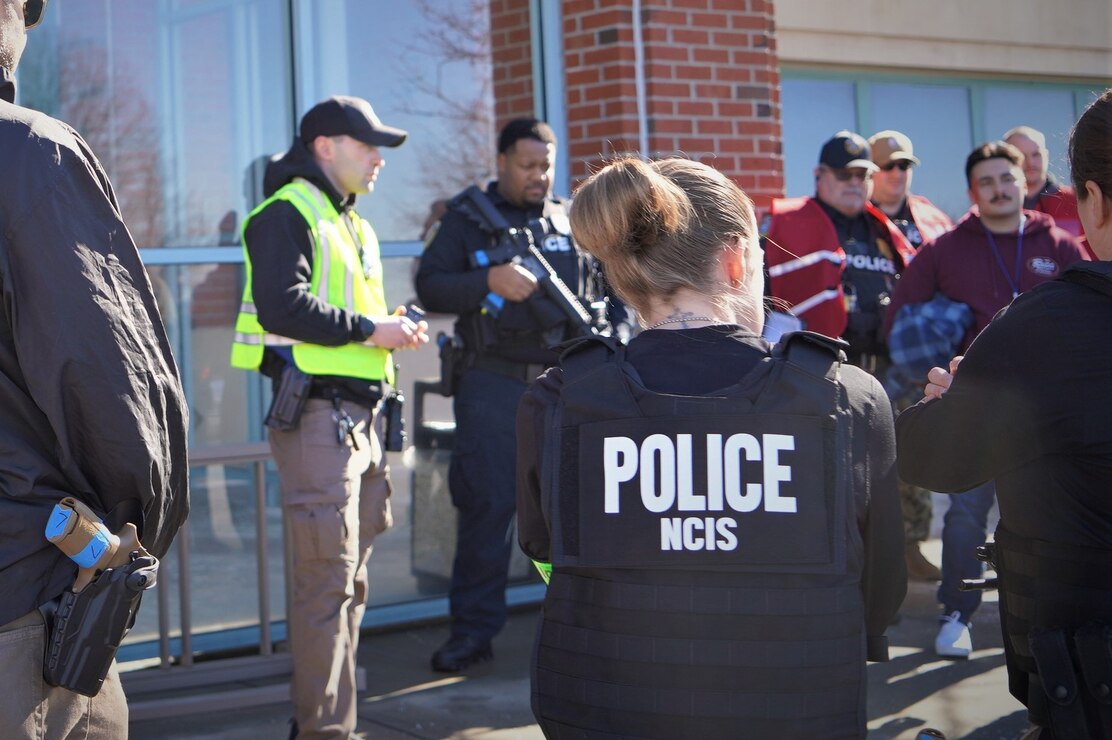 Law enforcements agents from the Installation Security Department, the Newport County Special Response Team, and the regional office of Naval Criminal Investigative Service conduct a hot wash at the Navy Medicine Readiness and Training Center New England following an active shooter exercise conducted there as part of the annual Exercise Citadel Shield Feb. 8, 2024.