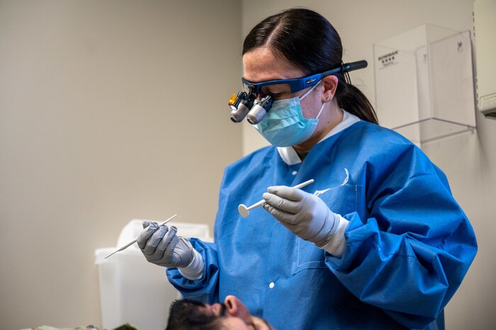 Maj. Emily Steiner, a 911th Aeromedical Staging Squadron general dentist, performs an oral examination at the Pittsburgh International Airport Air Reserve Station dental clinic, Pennsylvania, Feb. 3, 2024. Air Force dentists diagnose and treat oral diseases and abnormalities, review results and treatment plans and perform routine preventative exams. (U.S. Air Force photo by Staff Sgt. Timothy Leddick)