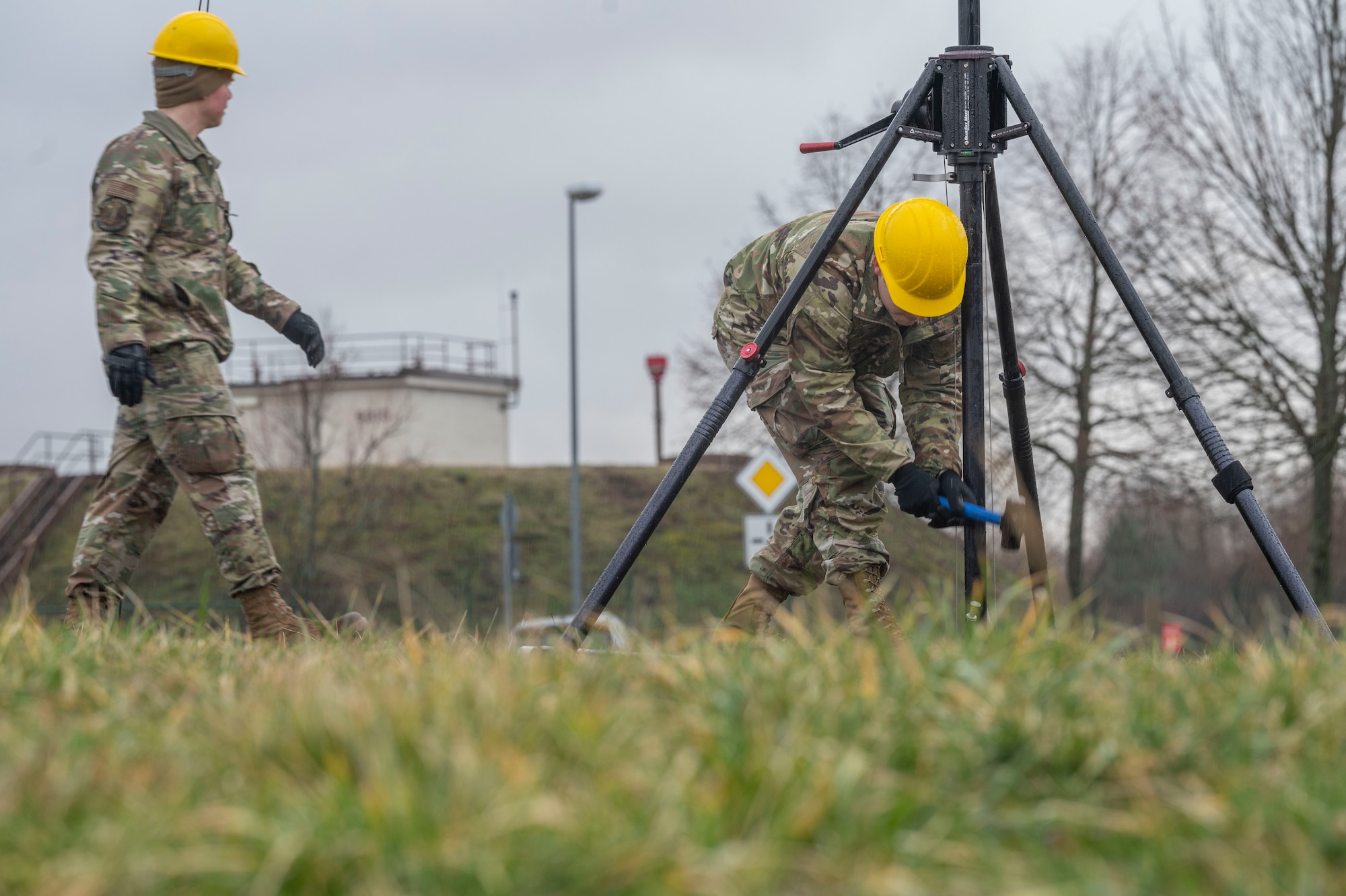 A man uses a hammer to secure an antenna