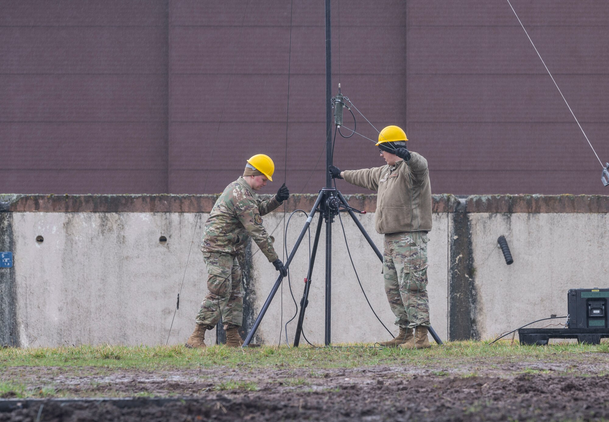 Two people set up an antenna