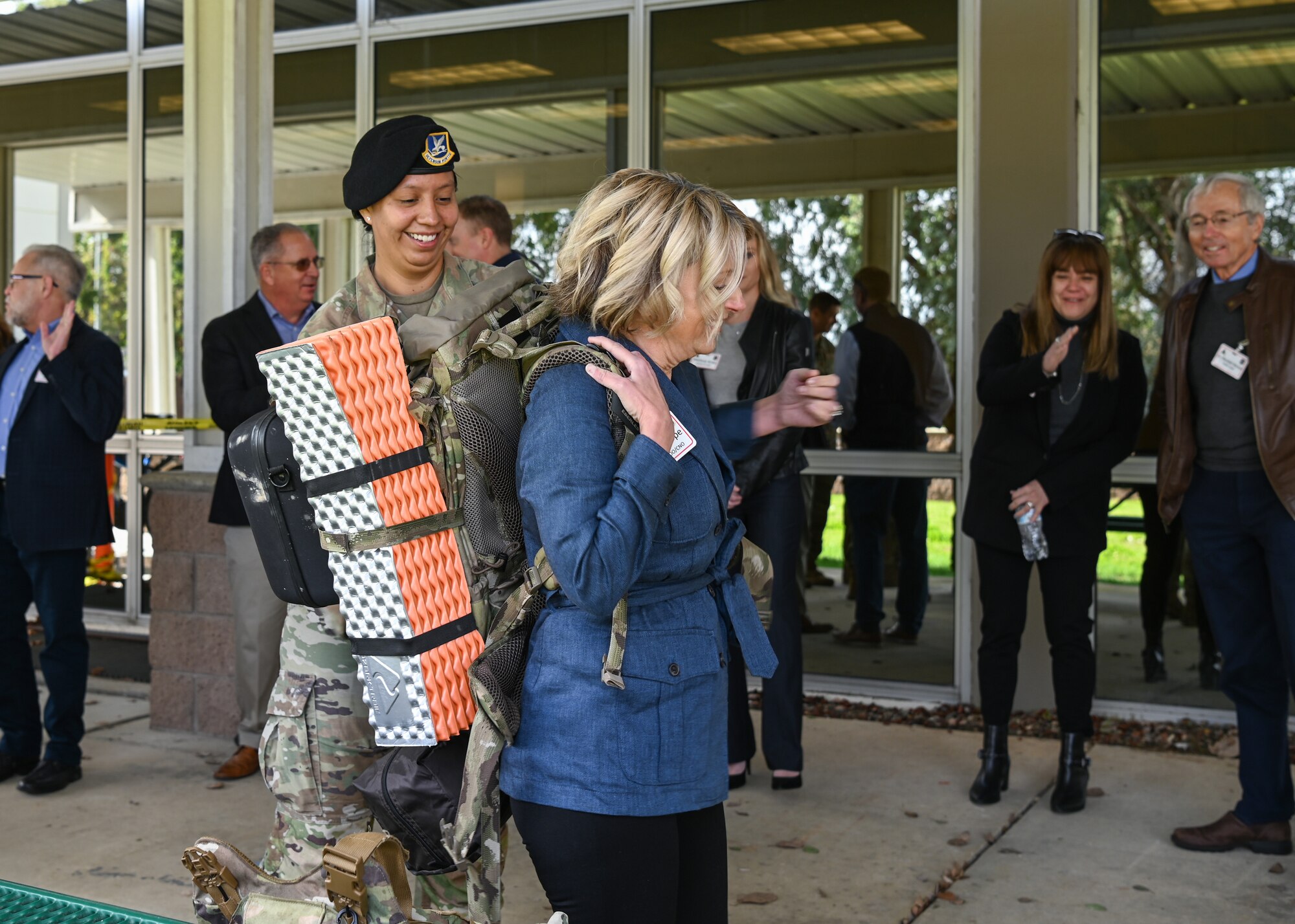 A 30th Security Forces Squadron counter small unmanned aerial systems noncommissioned officer, shows a Health Net member how to properly put on gear during a Medical Leadership Summit tour at Vandenberg Space Force Base.