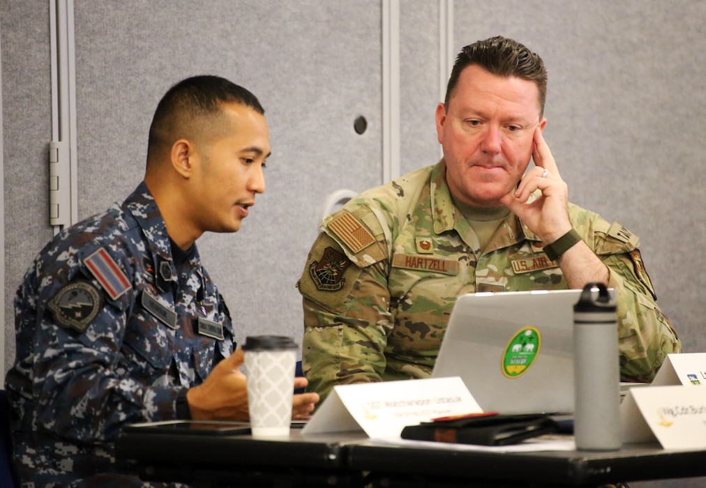 U.S. Air Force Lt. Col. Travis Hartzell, right, commander, 116th Air Support Operations Squadron speaks with his Royal Thai Air Force counterpart during the Enduring Partners 2024 final planning conference at Camp Murray, Wash. Feb. 6, 2024.