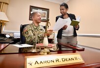 Brig. Gen. Aaron R. Dean II, The Adjutant General of the District of Columbia National Guard, and Ms. Lesley D. Little, executive assistant, Office of the Adjutant General, review a memo following an end-of-day meeting at the D.C. Armory, Feb. 6, 2024. As the principal advisor to the Commanding General, Brig. Gen. Dean overseas all aspects and impacts of legislation, policies, procedures, and programs. He celebrates 42 years of service next month.