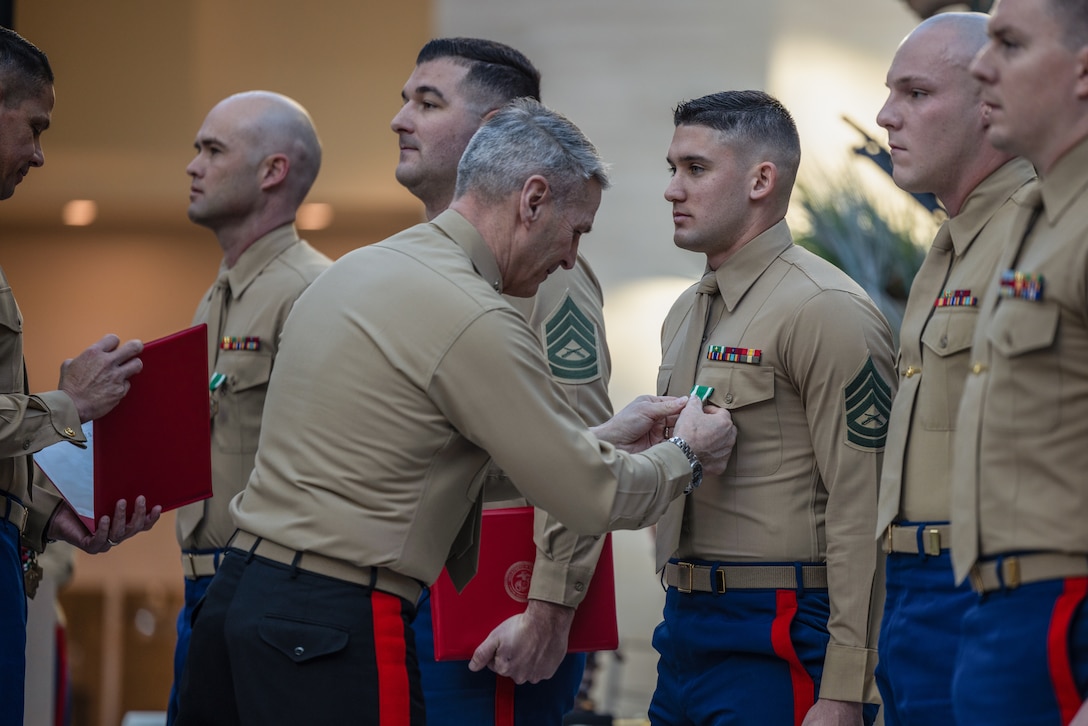 U.S. Marine Corps Gunnery Sgt. Bryan V. Labiosa, a drill instructor with Marine Corps Recruit Depot Parris Island, is awarded as the Drill Instructor of the Year by Gen. Christopher J. Mahoney, assistant commandant of the Marine Corps, during the Fiscal Year 2023 Commandant’s Combined Awards Ceremony at The National Museum of the Marine Corps, Triangle, Virginia, Feb. 8, 2024. The ceremony recognized and awarded eight Marines with the Navy and Marine Corps Commendation Medal for their exceptional performance in their respective special duty assignments. (U.S. Marine Corps photo by Lance Cpl. Ethan Miller)