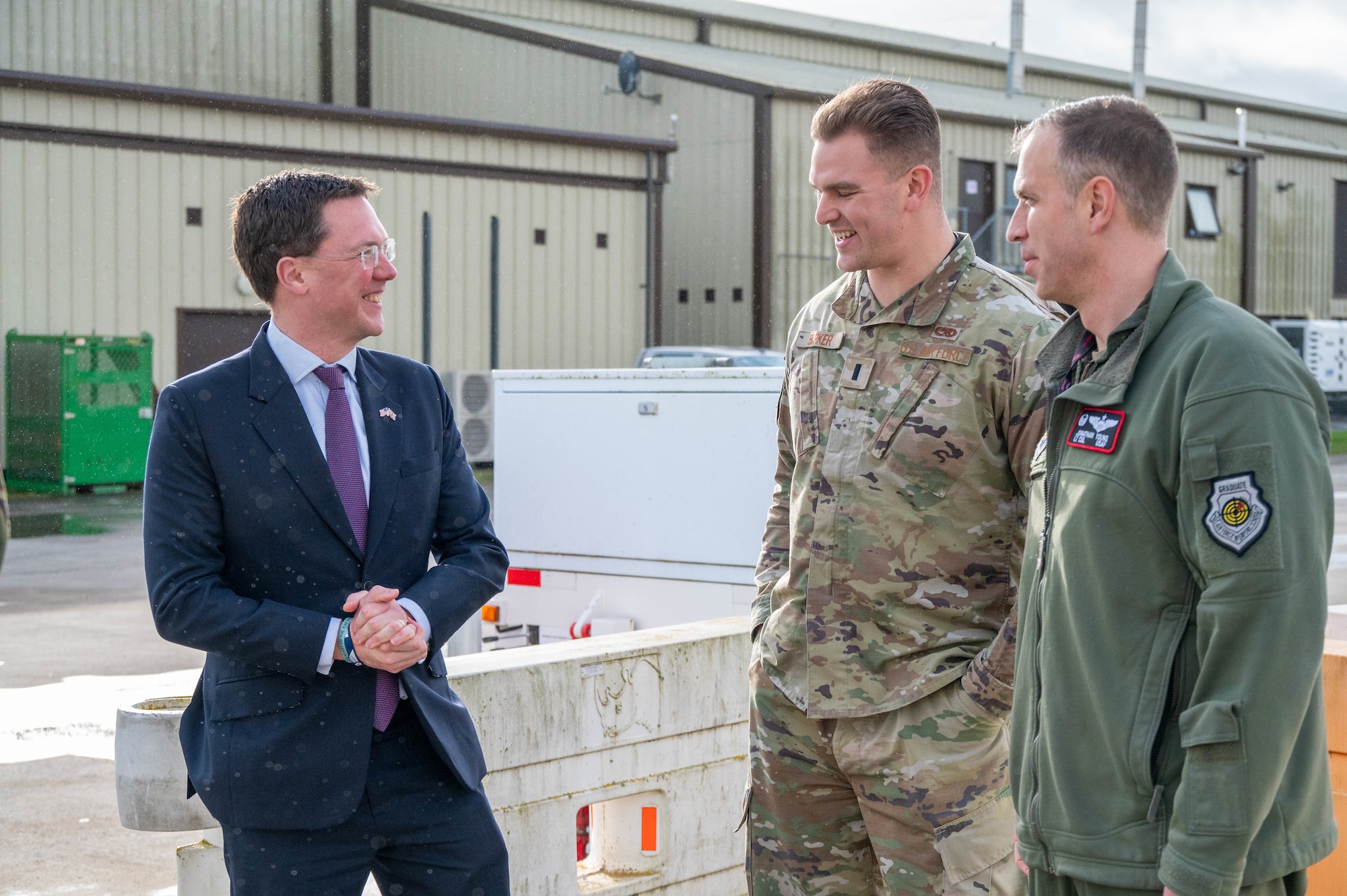 Members of the 99th Expeditionary Reconnaissance Squadron speak with Member of Parliament Robert Courts