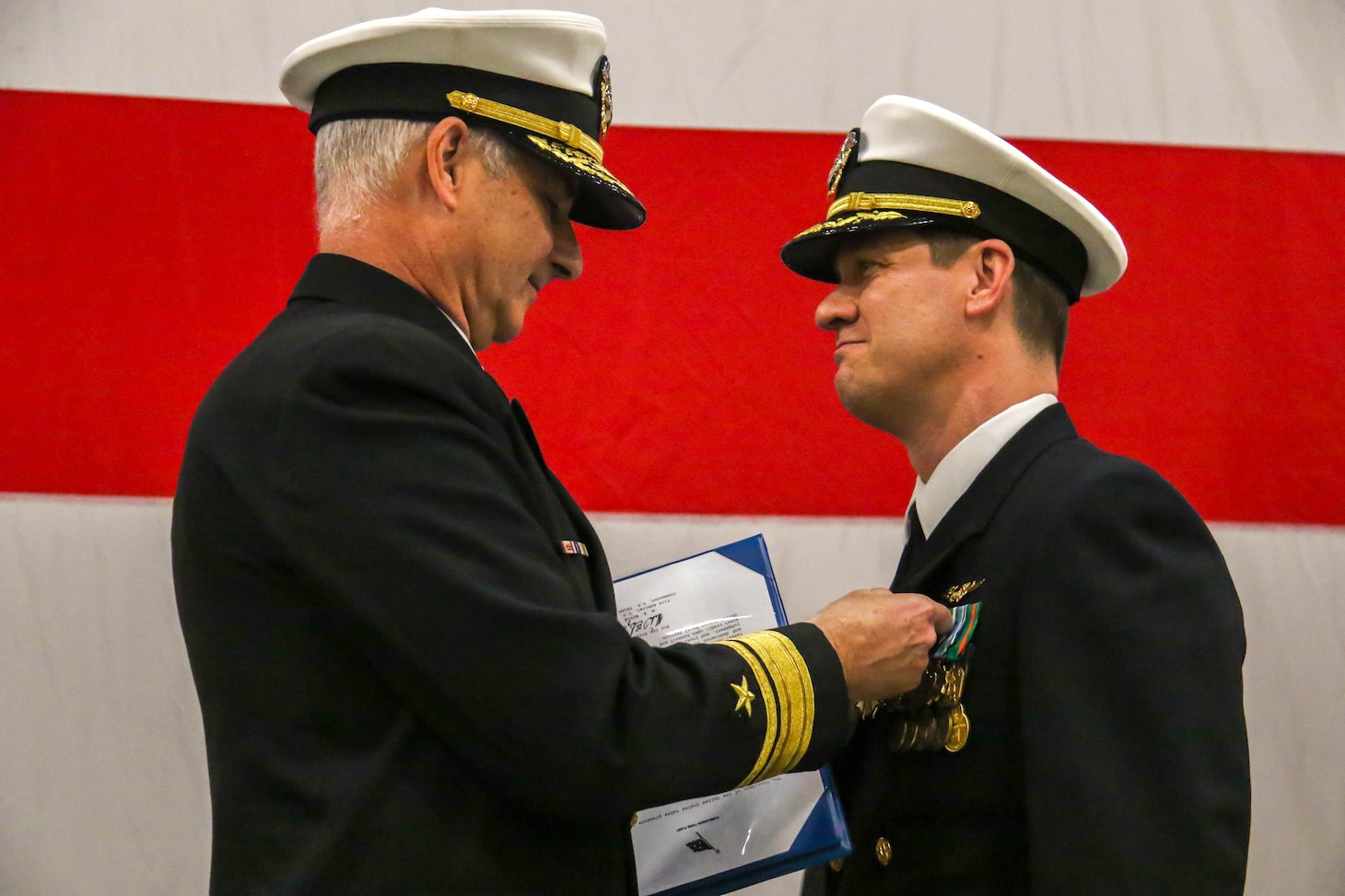 240202-N-IJ992-1429 OAK HARBOR, Wash. (Feb. 02, 2024) Rear Adm. Doug Verissimo, Commander Naval Air Forces, left, awards Capt. David Harris during the change of command ceremony of Electronic Attack Wing, U.S. Pacific Fleet, aboard Naval Air Station Whidbey Island (NASWI). Capt. David A. Ganci relieved Capt. David F. Harris as the commanding officer. (U.S. Navy photo by Mass Communication Specialist 2nd Class Andy Anderson)