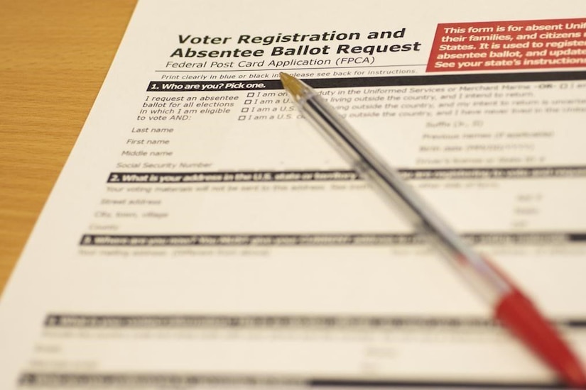 A voter registration and absentee ballot request is photographed.