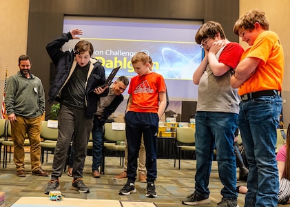 IMAGE: Naval Surface Warfare Center Dahlgren Division’s Michael Clark and Technical Director Dale Sisson Jr., P.E., SES, watch as the Richmond County Middle School team celebrates as their robot completes its mission during the Innovation Challenge @ Dahlgren: Middle School Robotics competition at the University of Mary Washington Dahlgren Campus, Feb. 10.