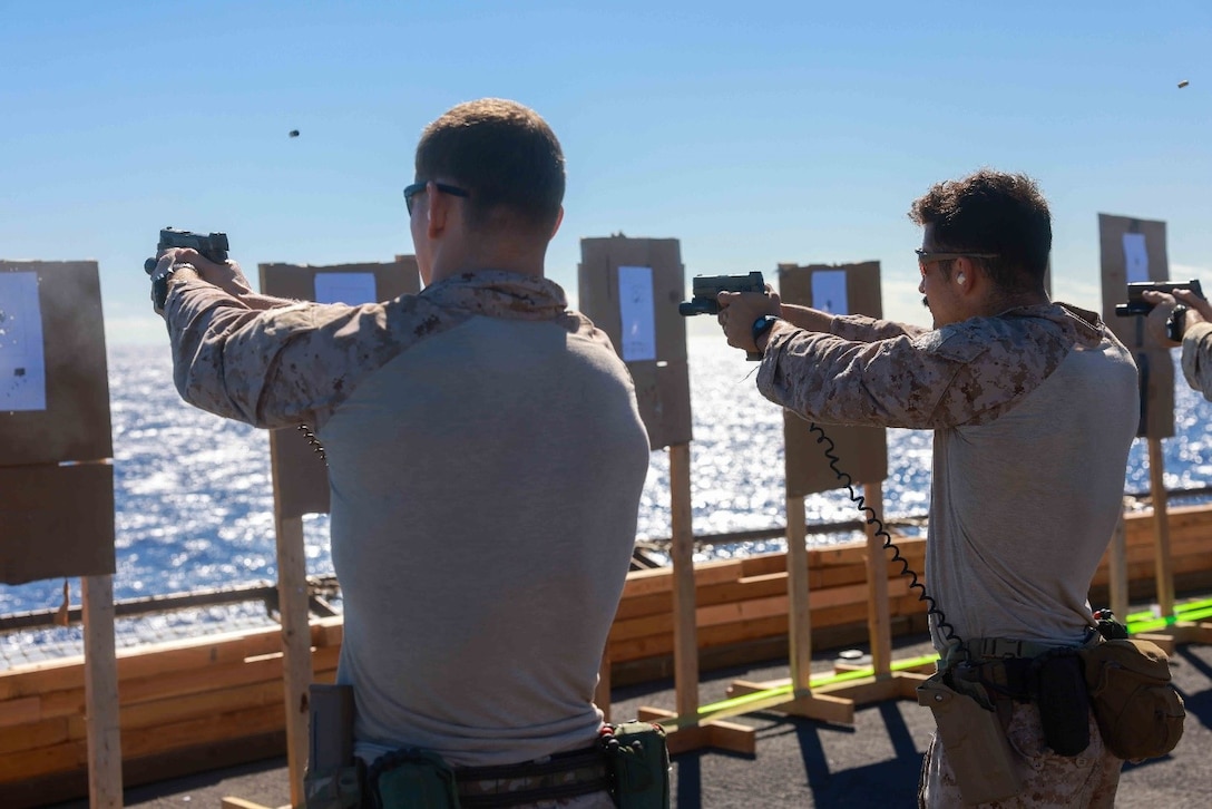 U.S. Marines assigned to Reconnaissance Company, 15th Marine Expeditionary Unit, engage targets with M18 pistols during a live-fire range on the flight deck of the amphibious transport dock USS Somerset (LPD 25) while underway in the Pacific Ocean, Feb. 8, 2024.