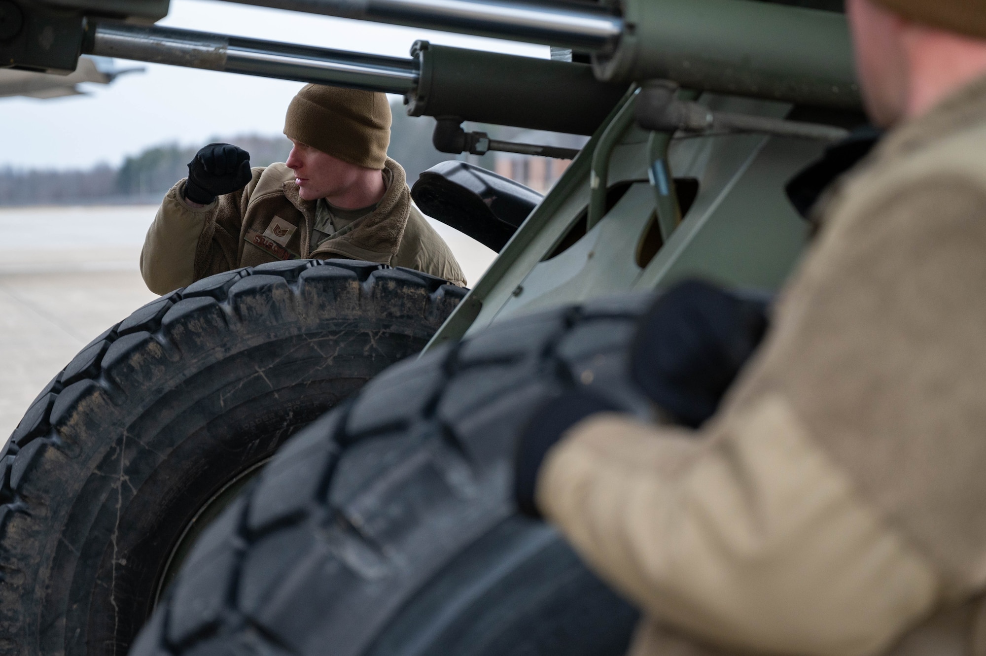 Tech. Sgt. Jonathan Soisson, 32nd Aerial Port Squadron air transportation specialist, uses hand signals to communicate adjustments for a 10K All-Terrain forklift at Youngstown Air Reserve Station, Ohio, Jan. 6, 2024. Hand signals were crucial for visual communication between crew members as the engines of an aircraft can overpower auditory communications. (U.S. Air Force photo by Tech. Sgt. Lucas M. Weber)