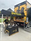 two men standing under an Army tent