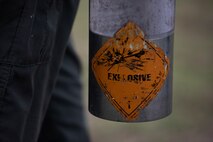 A U.S. Marine Corps explosive ordnance disposal technician with Headquarters Battalion, Marine Corps Base Hawaii, carries explosive charges for a demonstration on their new explosives range, MCBH, Nov. 21, 2023. The new range enhances the capabilities of EOD, allowing Marines to do tests and demonstrations without leaving the premises of their facility.