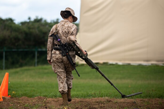 U.S. Marine Corps Staff Sgt. Miranda K. GarciaRivera, a distribution management specialist with Headquarters Battalion, Marine Corps Base Hawaii, practices the proper usage and implementation of a mine detector, MCBH, Jan. 9, 2024. The mine detector class was held during the battalion’s first field training exercise of 2024 in order to increase combat readiness, unit morale and camaraderie. (U.S. Marine Corps photo by Lance Cpl. Hunter Jones)