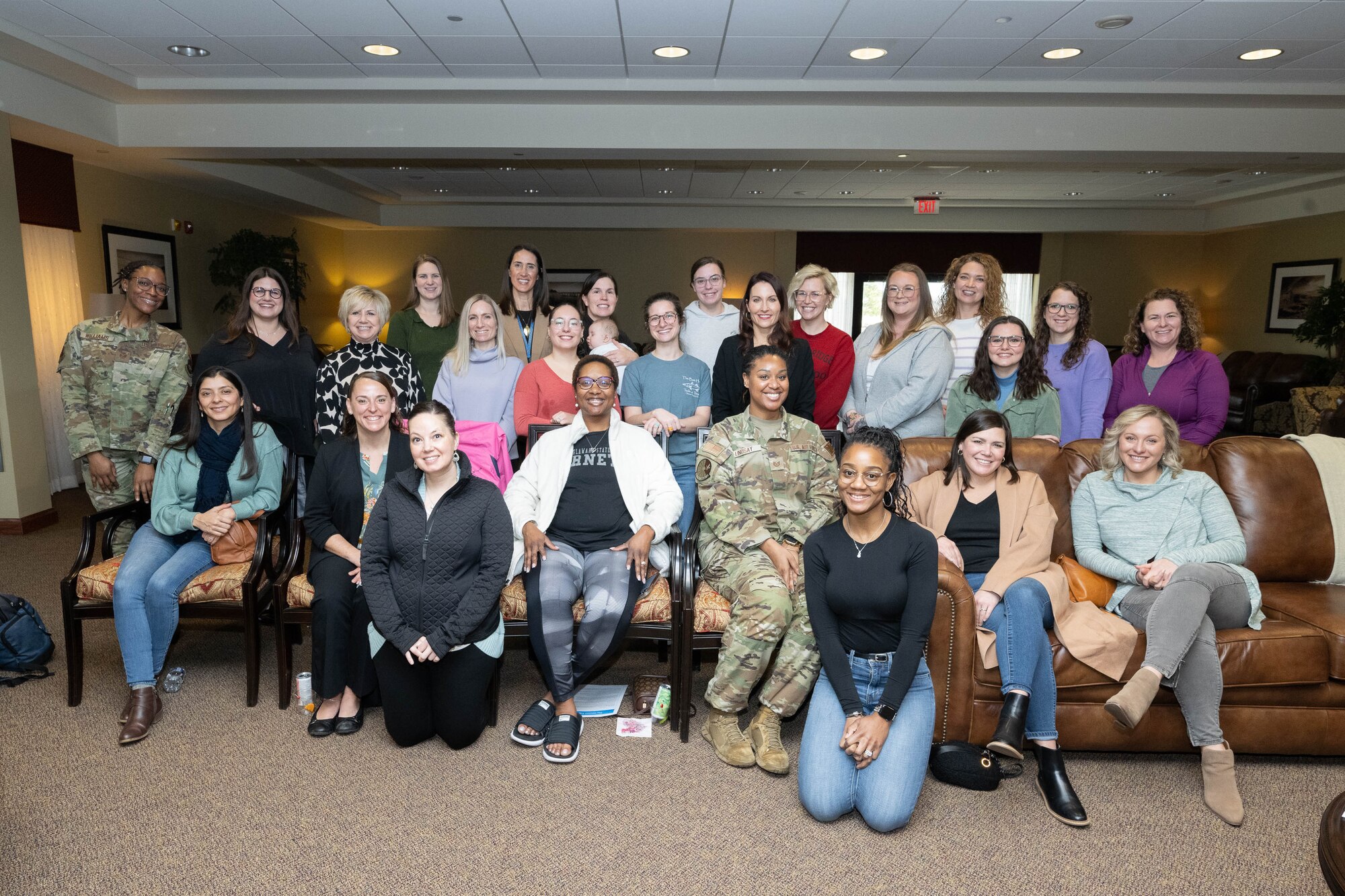 Dr. Janelle MacAulay, leadership and human performance consultant, poses with a group of military spouses at Dover Air Force Base, Delaware, Feb. 8, 2024. MacAulay was one of two keynote speakers at the Warrior Heart event, that aims at helping Airmen and their families fine tune their mind, body and craft to help ensure individual, team and family readiness in preparation for future challenges. (U.S. Air Force photo by Mauricio Campino)