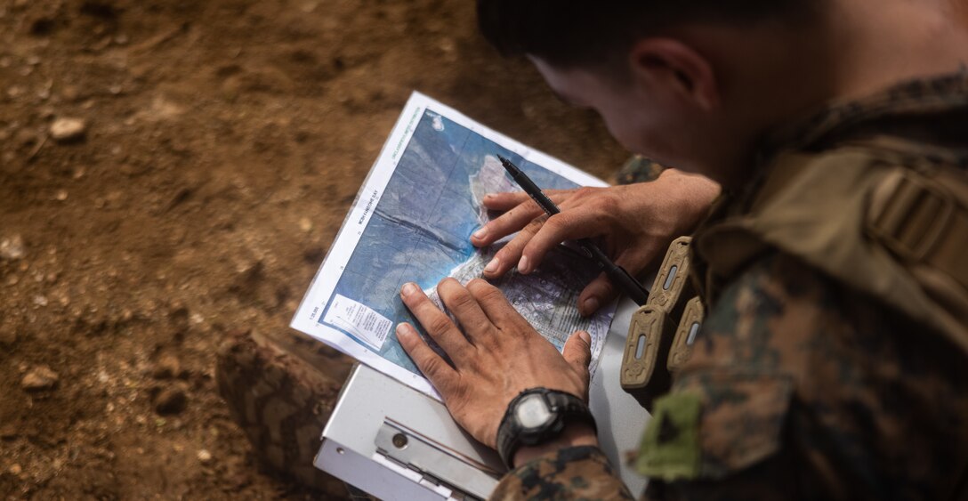 U.S. Marine Corps Cpl. Joshua Vega conducts call for fire transmissions during an annual squad competition at Marine Corps Base Hawaii, Nov. 28, 2023.  The competition was designed to test the Marines’ physical fitness levels, improve tactical proficiency, and build unit cohesion. Vega is an infantryman with 3d Littoral Combat Team, 3d Marine Littoral Regiment, 3d Marine Division, and a California native. (U.S. Marine Corps photo by Cpl. Malia Sparks)