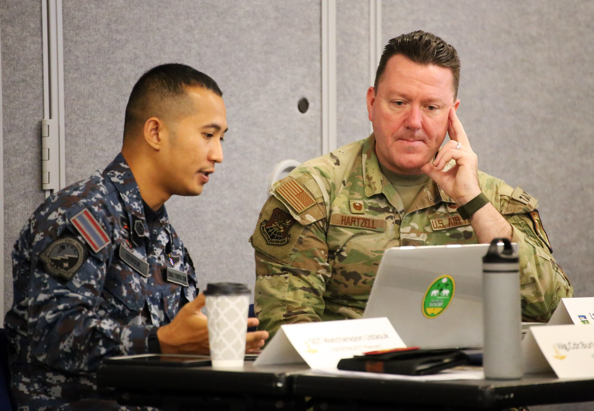 U.S. Air Force Lt. Col. Travis Hartzell, right, commander, 116th Air Support Operations Squadron speaks with his Royal Thai Air Force counterpart during the Enduring Partners 2024 final planning conference at Camp Murray, Wash. Feb. 6, 2024.