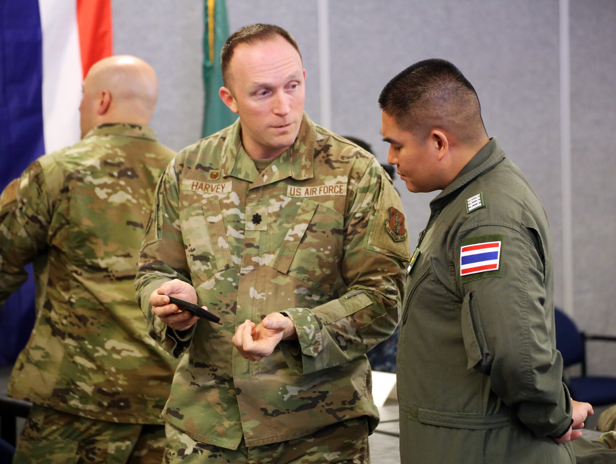 U.S. Air Force Lt. Col. Matt Harvey, Commander, 194th Logistics Readiness Squadron talks with a member of the Royal Thai Air Force during the Enduring Partners 2024 final planning conference at Camp Murray, Wash. on Feb. 6, 2024.