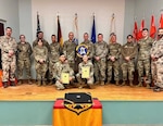 Two Airmen pose for a photo with their German Armed Forces Proficiency Badge certificates.