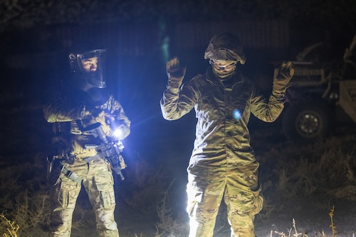 U.S. Air Force Senior Airman Jean Novenario, 9th Security Forces Squadron military working dog handler, detains 1st Lt. Elizabeth Babbitt, 9th Operations Support Squadron airfield operations flight commander from Beale Air Force Base, California, during Exercise Dragon Trident 1 at Fallon, Nevada, Jan. 29, 2024.