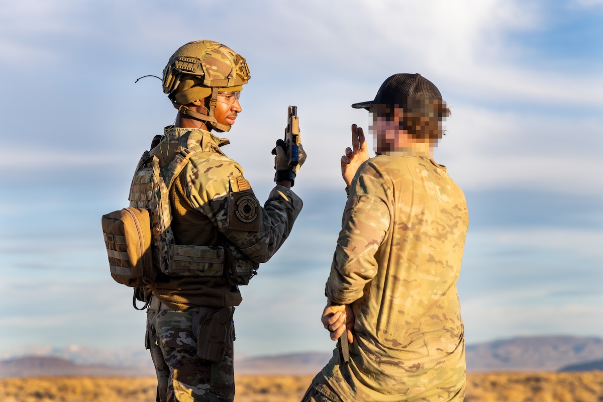U.S. Air Force Airman 1st Class Jahmir White, 9th Security Forces Squadron (SFS) installation entry controller, Beale Air Force Base, California, receives weapons training from an East Coast-based Naval Special Warfare Operator (SEAL) at Fallon, Nevada, Jan. 30, 2024.