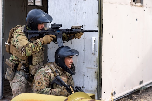 U.S. Air Force Senior Airman Jean Novenario, 9th Security Forces Squadron (SFS) military working dog handler (left) and Staff Sgt. Braddy Alibangbang, 9 SFS plans and programs NCO in charge from Beale Air Force Base, California, infiltrate a forward operating site at Fallon, Nevada, Jan. 31, 2024.