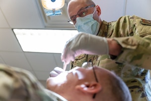 Lt. Col. Sean Noonan, a 911th Aeromedical Staging Squadron dentist, performs an oral examination at the Pittsburgh International Airport Air Reserve Station dental clinic, Pennsylvania, Feb. 2, 2024. The Air Force Reserve dental clinic’s primary function is to diagnose oral pathology and disease. (U.S. Air Force photo by Staff Sgt. Timothy Leddick)