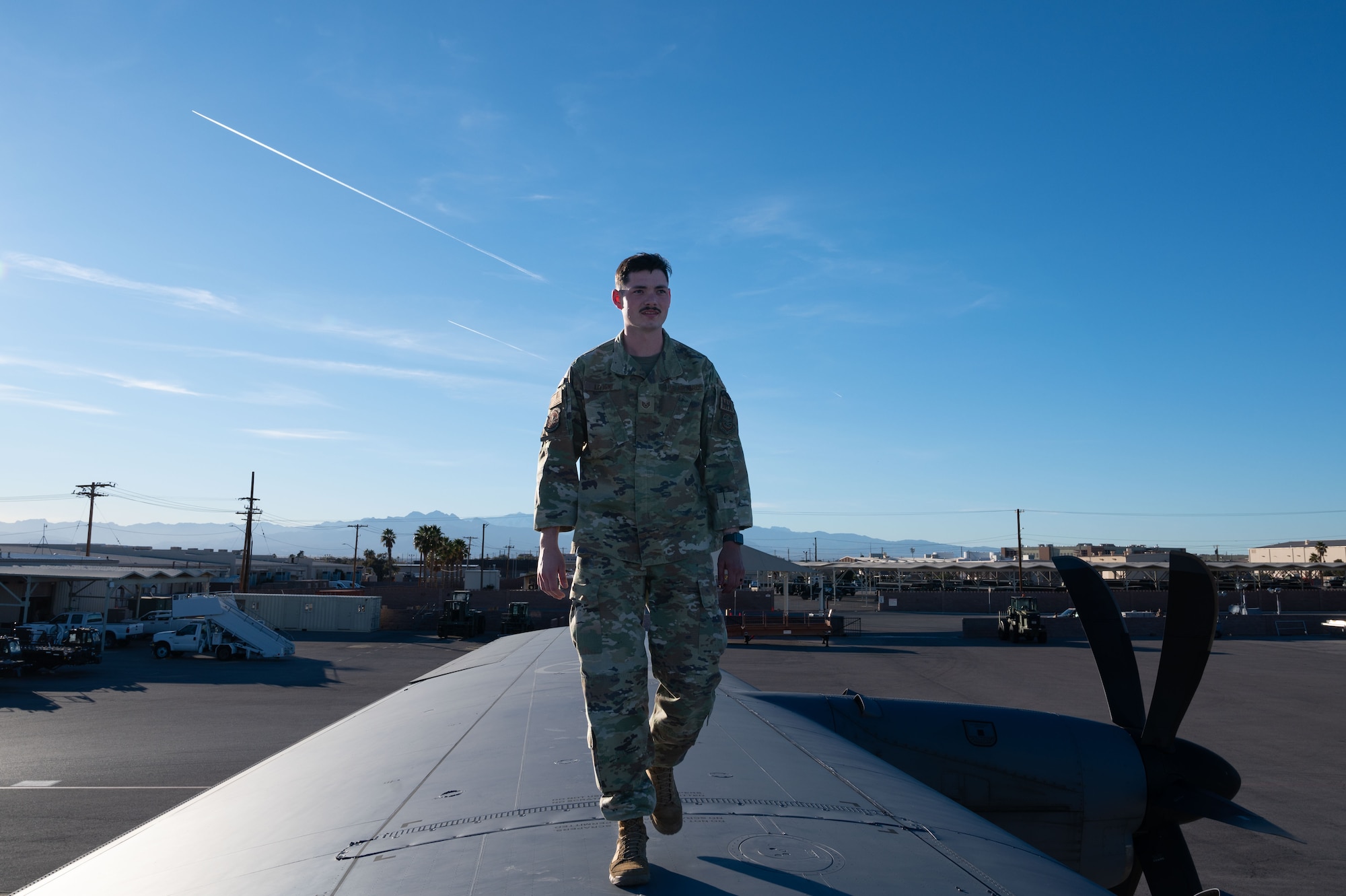 U.S. Air Force Staff Sgt. Blake Livigni, a 317th Aircraft Maintenance Squadron aircraft maintenance technician assigned to the Dyess Air Force Base, Texas, walks on the wing of a C-130J Super Hercules during Bamboo Eagle 24-1 at Nellis Air Force Base, Nevada, Jan. 29, 2024. Over 3,000 U.S. service members across four branches flew, maintained and supported more than 150 aircraft from over 20 units in multiple locations during Bamboo Eagle. (U.S. Air Force photo by Airman 1st Class Timothy Perish)
