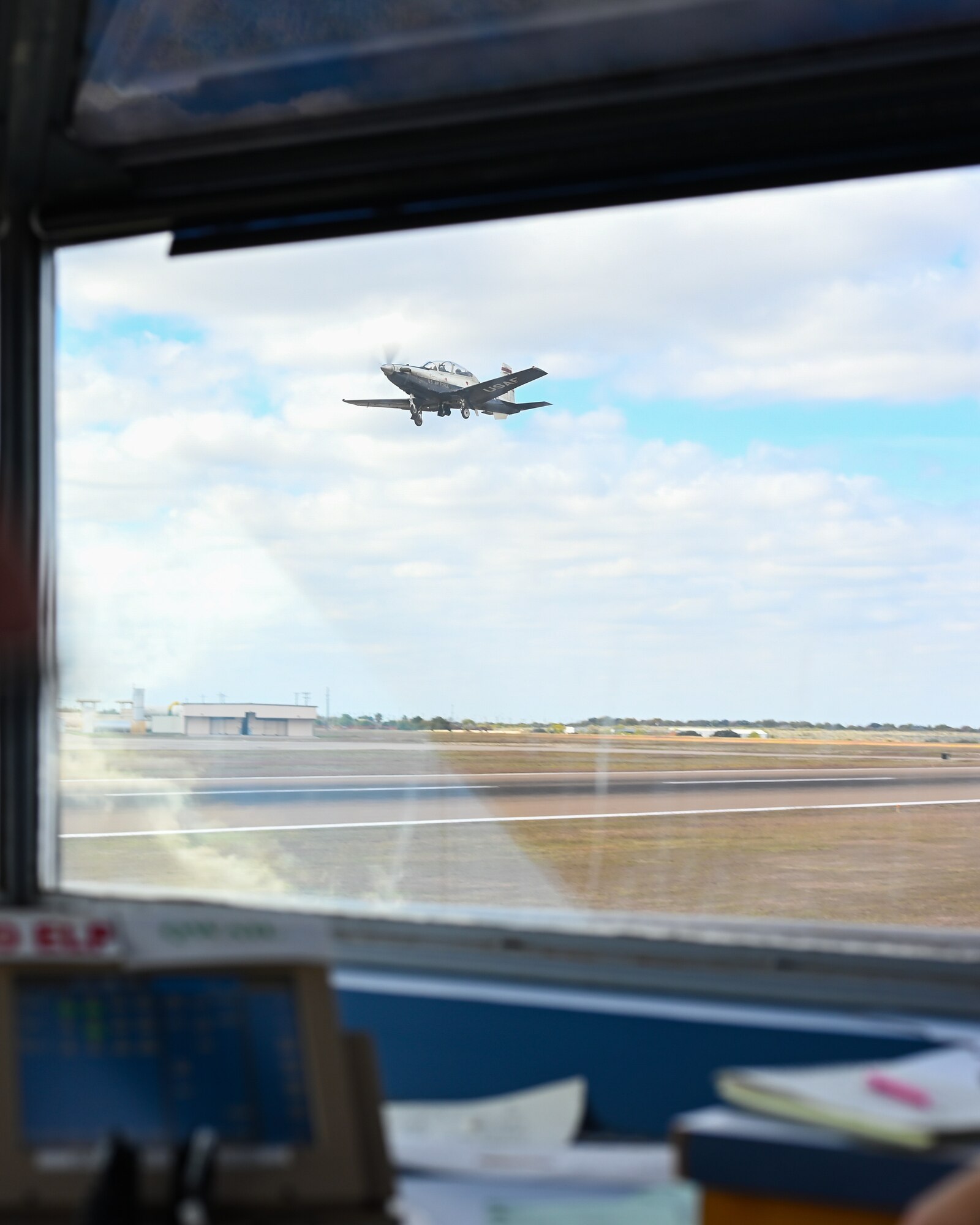 Viewed from the window of a runway supervisory unit, a U.S. Air Force T-6A Texan II takes off at Laughlin Air Force Base, Texas, Dec. 7, 2023.