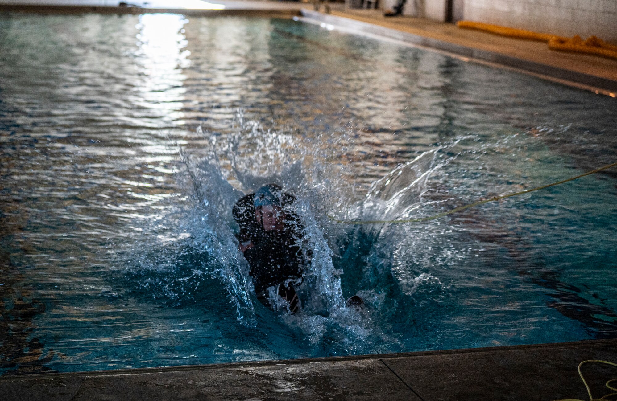 Mike Roberts, a government contractor, is pulled into the pool by a harness at Moody Air Force Base, Georgia, Feb. 8, 2024. Forward and reverse harness drags were performed to prepare Airmen for real-world emergencies. (U.S. Air Force photo by Airman 1st Class Leonid Soubbotine)