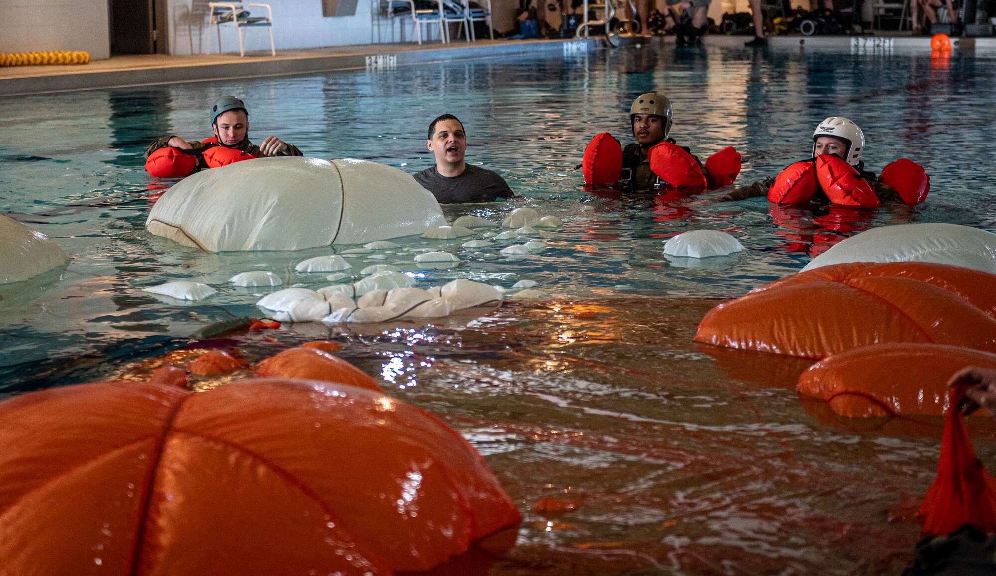 U.S. Air Force Staff Sgt. Michael Ferraro, 347th Operations Support Squadron Survival, Evasion, Resistance and Escape specialist, goes over emergency parachute procedures at Moody Air Force Base, Georgia, Feb. 8, 2024. Aircrew members must conduct water survival training to ensure combat readiness. (U.S. Air Force photo by Airman 1st Class Leonid Soubbotine)