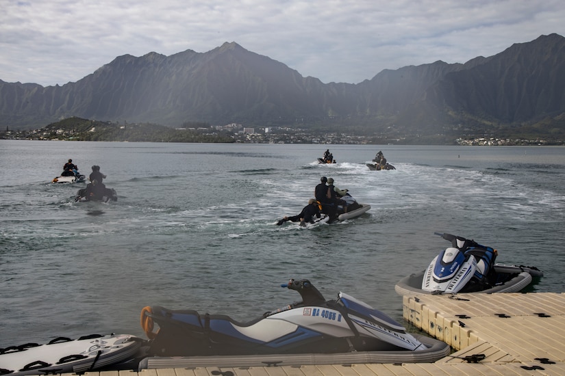 Troops on two-person watercrafts train for reconnaissance at sea.