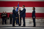 Brig. Gen. David May, Adjutant General for Air, Wisconsin National Guard, passes the wing guidon to Col. Charles Merkel as he takes command of the 128th Air Refueling Wing, here at Milwaukee Mitchell Airfield, Feb. 3, 2024. The passing of colors from an outgoing commander to an incoming one ensures the unit and its Airmen are never without official leadership, a continuation of trust. (U.S. Air National Guard photo by Airman 1st Class Cynthia Yang)