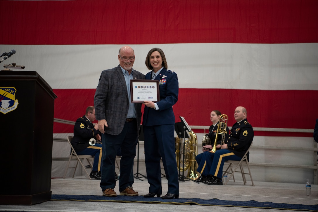 Col. Adria Zuccaro, outgoing commander of the 128th Air Refueling Wing, receives the Seven Seals Award from the Wisconsin chapter of the ESGR at the change of command ceremony, here at Milwaukee Mitchell Airfield, Feb. 3, 2024. The passing of colors from an outgoing commander to an incoming one ensures the unit and its Airmen are never without official leadership, a continuation of trust. (U.S. Air National Guard photo by Airman 1st Class Cynthia Yang)