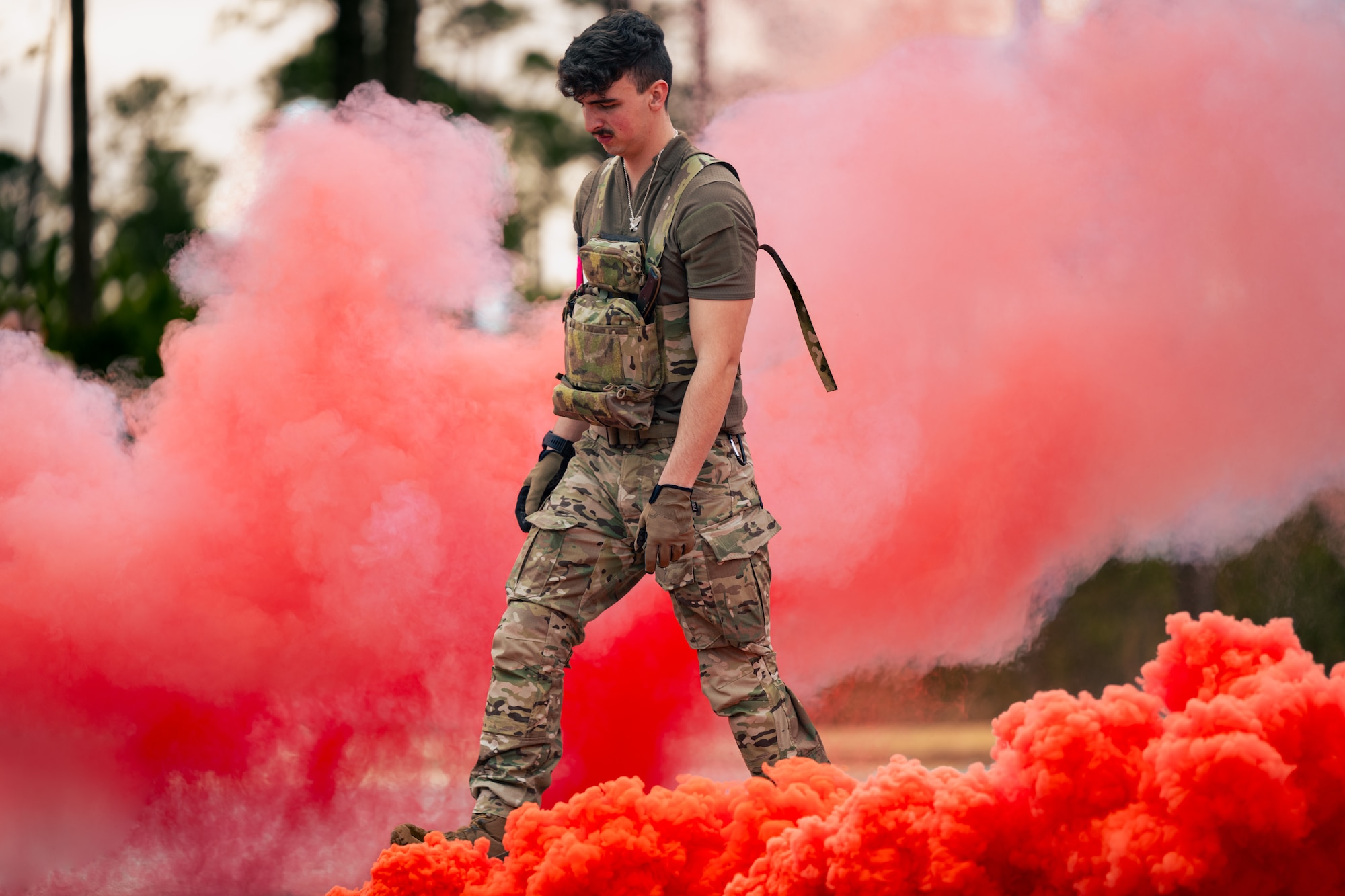 U.S. Air Force Airman 1st Class Cameron Crandall, a 1st Special Operations Support Squadron survival, escape, resistance, and evasion specialist, walks through smoke during a SERE training at the Eglin Range, Florida, Feb. 8, 2024.